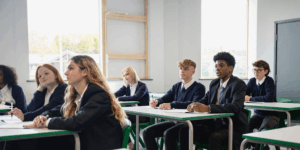 Group of multiracial, mixed gender schoolchildren, sat at their desks